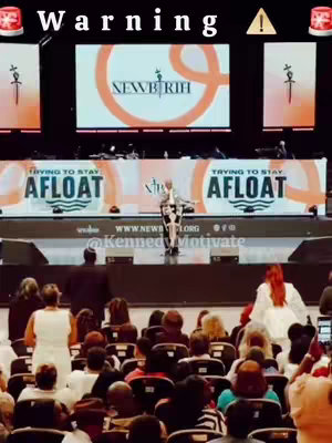 The cover image shows a male speaker on a stage addressing a large audience. Above the speaker, there's a digital display showing a brand logo. The image is slightly low-resolution, and the color scheme appears warm, with amber and orange tones dominating. Text overlays are placed across the top of the image within a banner.