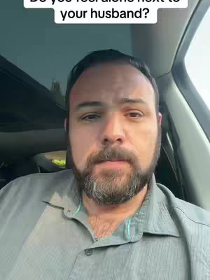 A man with a beard is seated in a car, looking directly at the camera. The background shows elements of the car interior, focusing on the man with the headline above.
