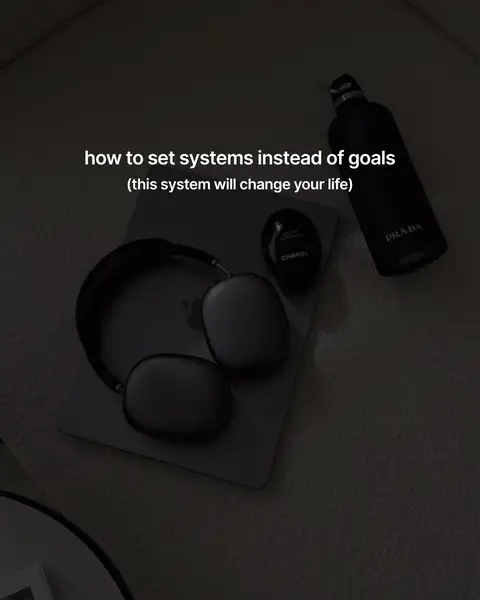 A top-down shot shows a minimalist setup on a light-colored surface. There's a laptop at the center, with a pair of headphones draped over it. To the right, a dark Prada perfume bottle and a small Chanel perfume bottle add a touch of luxury. The text overlay provides context.