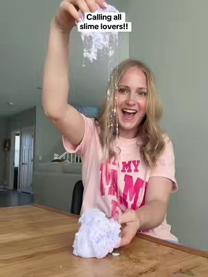 The cover image features a woman smiling and holding up a handful of purple slime, with more slime falling from her lifted hand. Text overlayed at the top reads 'Calling all slime lovers!!'