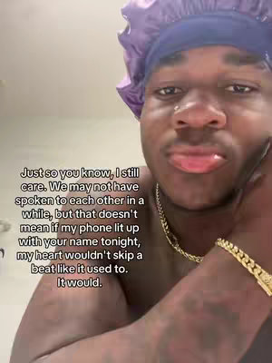 A selfie-style shot of a man with dark skin, wearing a purple bonnet, looking at the camera with a slightly distressed expression. Text is overlaid on the image.