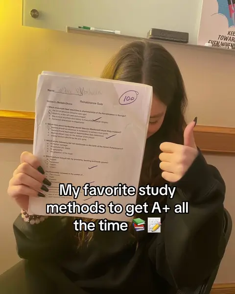 A young woman holds up a quiz paper with a grade of 100, giving a thumbs-up. The text overlay reads 'My favorite study methods to get A+ all the time'. The background shows an interior setting.