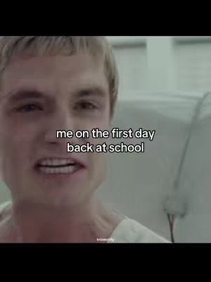 The image features a person, likely a male, with blonde hair and a visible facial expression. The photo has text overlays, and the background is blurred.
