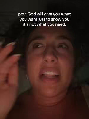 A close-up shot of a woman expressing emotion. Her eyes are wide with a concerned or distressed look, and her mouth is slightly open as if she is speaking or about to speak. The background is blurred and dark, suggesting a dimly lit environment.