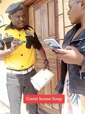 A man in a police-like uniform is talking to a person holding a phone. A sign in the bottom right says 'Guest house Soap'.