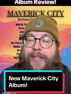 A man with a beard and glasses is centered in a frame. The image features a warm color scheme with a background gradient from yellow to orange. A logo with a deer in a circle is visible on a stylish hat. Text overlays include 'Album Review!' at the top, the band name 'MAVERICK CITY', and 'New Maverick City Album!' in a bottom black box with green borders.
