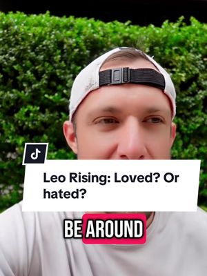 The cover image features a man wearing a white baseball cap, set against a backdrop of green foliage. A question bubble with text 'Leo Rising: Loved? Or hated?' is overlaid, along with the words 'BE AROUND' in a red box at the bottom. A TikTok logo is visible in the upper left corner.
