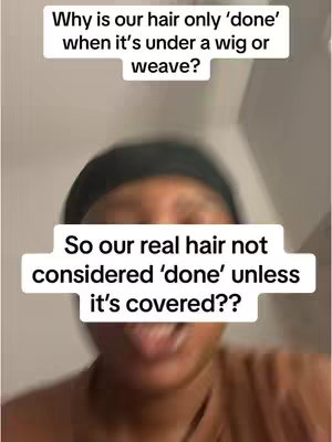 The image is a vertical, selfie-style shot. The creator, a Black woman, fills a significant portion of the frame, seen from the chest up. She's positioned centrally, with her face clearly visible and slightly angled. She has dark hair that is covered with a black head covering against the light background and her face is smiling. The background is a plain, neutral wall. The top half of the image includes two text boxes that contain text. The overall composition suggests a focus on the creator's expression. The colors are natural with soft lighting.