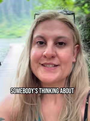 A woman with blonde hair smiles while standing in front of a blurred outdoor background. Sunglasses are perched atop her head, and text overlays the bottom of the image.