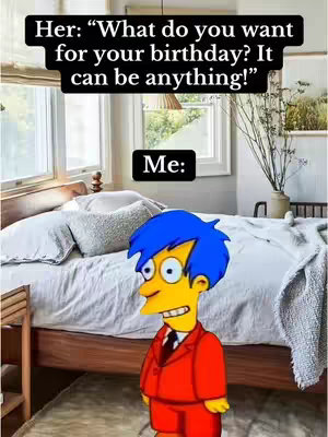 The image is a meme featuring a bedroom setting as the background. There is a bed with pillows and white linens. Above the cartoon character Milhouse from The Simpsons is a text overlay in a black box. An animated Milhouse from the Simpsons is present, and the cartoon has a yellow face with blue hair, wearing a red suit and black tie.