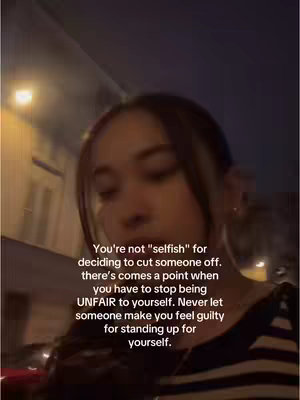 The cover image shows a young woman from a slightly low angle, set against a blurred, dark background suggesting a street scene at dusk or night. She appears to be looking down and away from the camera, her expression thoughtful or introspective, but the low light makes it difficult to discern clear facial features. Text overlayed on the image offers an inspirational quote.