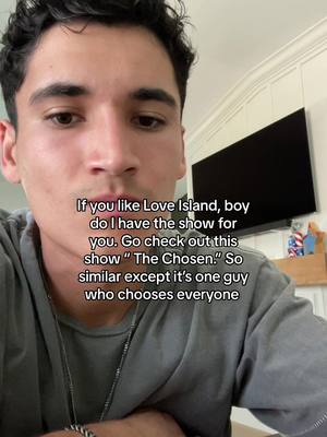 A selfie-style shot of a young man looking at the camera against an indoor background. Overlayed text is present.