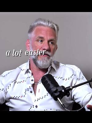 The cover image features a middle-aged man with gray hair and a beard. He is wearing a white shirt with a pattern of small colored dots. A microphone is positioned in front of him. The text overlay 'a lot easier' appears near his face.