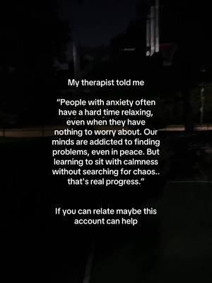 The image shows a dark outdoor scene, likely at night, with text overlaid. In the background, indistinct shapes suggest trees or other structures. The focus is on the text, which quotes a therapist discussing anxiety and the challenge of relaxation. The overall tone is serious and reflective.