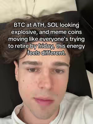 A selfie-style video cover featuring a young man in a white t-shirt, centered in the frame. Text overlayed at the top of the image discusses cryptocurrency trends. The man is positioned against a blurred background, the composition highlights his upper body and head.