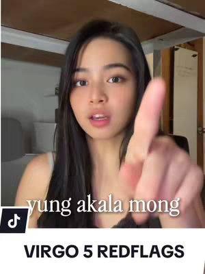 A young woman with long, dark hair is centered in the frame, looking directly at the camera. She's holding a finger up, pointing towards the viewer. Text overlaid on the image reads 'VIRGO 5 REDFLAGS'.