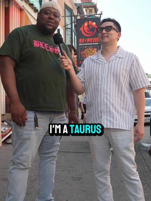 Two men are standing outside. The man on the left is holding a microphone, and the man on the right is being interviewed. There is text overlaid on the image that says "I'M A TAURUS."