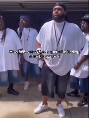 The cover image shows a group of Black men outdoors. The central figure stands forward, wearing a white t-shirt and black shorts. Other men in similar attire stand behind him, creating a sense of unity. Text overlays the image.