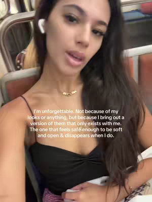 A selfie-style shot featuring a woman with long, dark hair, wearing a black top and a gold necklace. She has one AirPod in her ear and appears to be speaking. Text overlay provides context for the video's message.