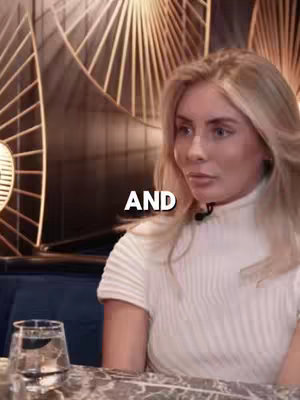 The cover image features a woman seated indoors. She faces the camera, with soft lighting and a white top. The background suggests a high-end restaurant or lounge, with decorative gold accents.