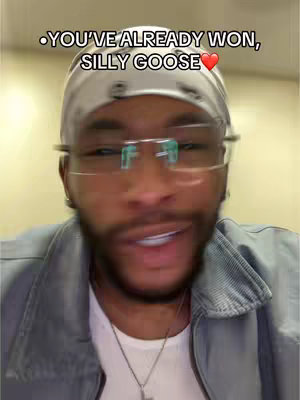 The cover image is a selfie of a Black man from the chest up. He has a black beard, wearing a white headscarf, glasses with green tinted lenses, a light blue jacket over a white shirt, and a silver necklace. Above his head, text is overlaid.