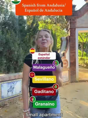 A woman stands in front of an archway, with trees and foliage visible in the background. She has several text labels overlayed on her, each with a regional dialect from Andalusia.