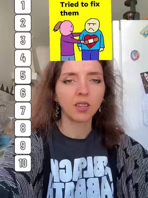 A woman is the primary focus of the image, her upper body filling the frame. She has shoulder-length brown hair. Above her head, a cartoon illustration shows two stick figures: a woman is trying to put a bandage on a sad-faced person.