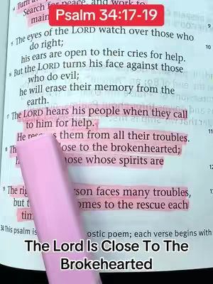 An open bible with highlighted verses in pink, featuring text overlays