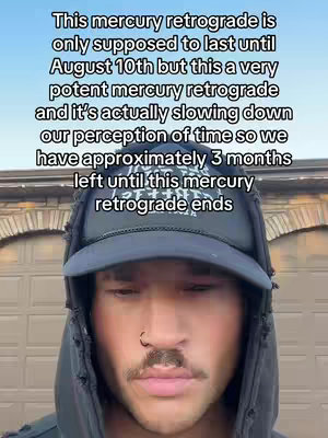 A man wearing a black hat and hoodie, with text overlaid on the image. The man has a nose ring and a mustache. The background appears to be a brick facade.