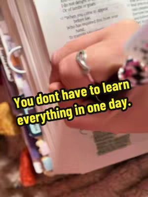 The image shows a hand with a ring on a finger holding open a bible, with text overlaid across the image.