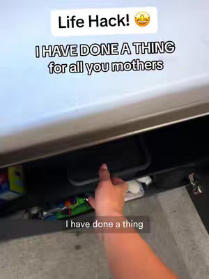 The image shows a hand reaching into a compartment under what seems to be a cabinet, with text overlayed on the image.
