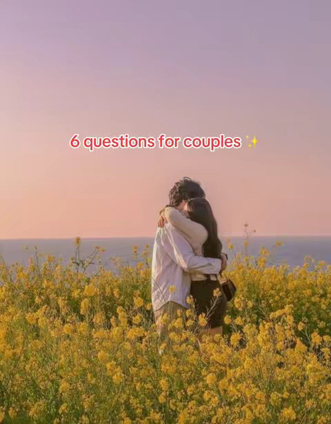 The image shows a couple embracing in a field of yellow flowers with the ocean and a sunset in the background. Text overlayed reads '6 questions for couples'.