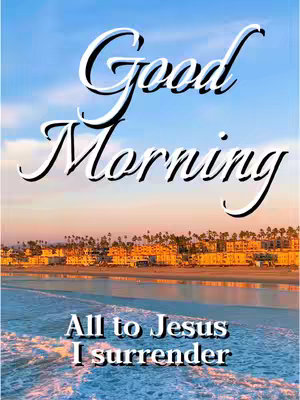 A serene image capturing a coastal scene at either sunrise or sunset. The sky transitions from shades of blue to soft oranges and yellows, suggesting dawn or dusk. Silhouetted buildings and trees line the horizon along the water. Overlaid in a curved white font is 'Good Morning', with additional text 'All to Jesus I Surrender' near the bottom. The overall composition is peaceful.