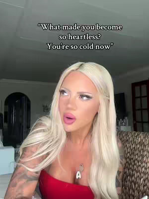 A woman with long blonde hair, wearing a red top is looking towards the camera with a slightly concerned expression. Text overlays the image.