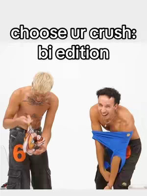 Two shirtless men stand in front of a white backdrop, each holding up an item of clothing. Text at the top asks the viewer to "choose ur crush: bi edition."