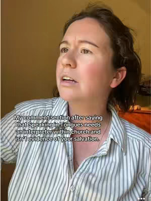 A woman with dark hair and fair skin is looking off to the side with a slightly concerned expression. She's wearing a striped button-down shirt. Text overlayed over the video states: 'My comment section after saying that Speaking in Tongues needs an interpreter within church and isn't evidence of your salvation'.