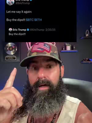 A man with a beard and camouflage hat points up at a tweet from Eric Trump about buying crypto dips.