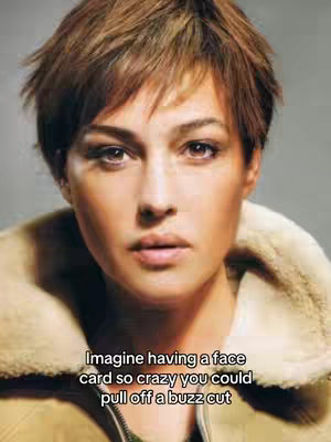 The cover image is a portrait of Monica Bellucci, with a focus on her face. She looks directly at the viewer. She is wearing a beige jacket with a fluffy collar. The background is a plain, blurred gray. A text overlay is present at the bottom of the image.