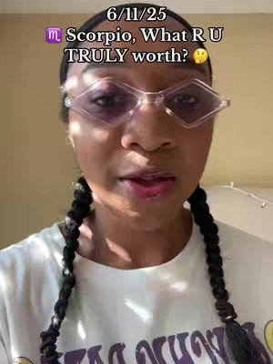 A medium shot of a woman with dark braids and diamond-shaped glasses. Text overlays the image.
