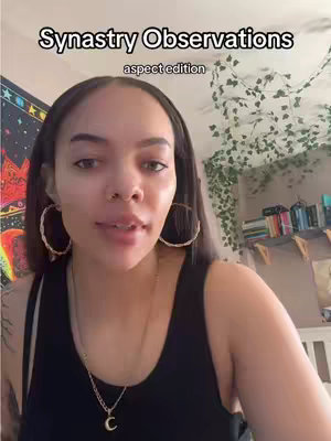 A woman with dark hair and hoop earrings is centered in the frame. Above her head is text that reads 'Synastry Observations', with the subtitle 'aspect edition'. The background includes decorative elements: a tapestry and a wall with hanging plants.