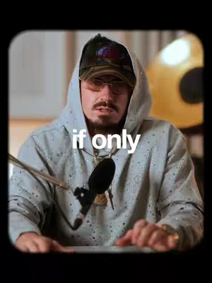 The cover image features a man in a hoodie and hat sitting at what appears to be a desk, with a microphone in front of him. The background includes soft lighting and a yellow object.