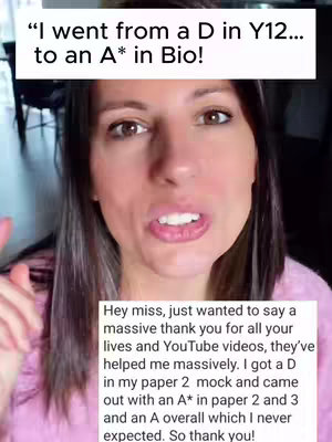 A selfie-style video cover image of a woman looking directly at the camera and speaking. Above her is a white rectangular text box with the caption "I went from a D in Y12... to an A* in Bio!". Below her is a smaller white text box that reveals commentary about a Biology masterclass. The woman has long brown hair and is wearing a pink top. The overall composition is a close-up shot.