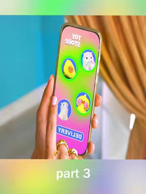 A hand holding a gold-framed phone with a pink and green gradient screen. The screen displays colorful icons within circles, including an animated avocado, a white cat, a duck, and a cat. The bottom of the image shows the text overlay on a colorful background.