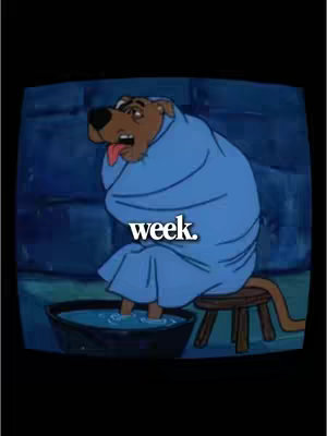 The cover image depicts cartoon Scooby-Doo wrapped in a blue towel, sitting on a stool with his feet in a basin of water. The background is a dark blue, suggesting a cool, indoor setting, and the text 'week' is superimposed on the image in white.