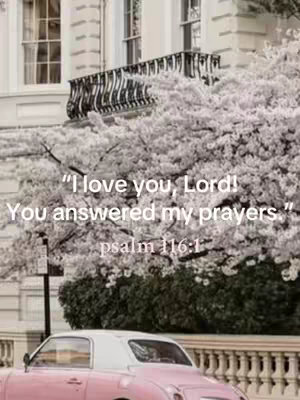 The image showcases a classic pink car parked on a street, with a building and blooming trees in grey and white in the background. Text overlays quote from Psalm 116:1.