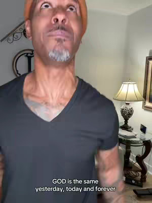 The video shows a close-up of a man looking upwards with text overlayed at the bottom of the screen. The background includes a room with a lamp, table and clock.