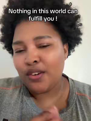 A close-up shot of a woman with dark, curly hair and light skin. The woman is looking slightly off-camera with her mouth open as if speaking. The background is a plain white wall. Overlayed on the image at the top is white text.