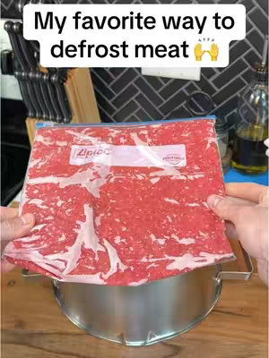 The cover image shows a close-up of a package of ground meat inside a clear plastic bag. The bag is held by a person's hands, and the meat is resting on a stainless steel bowl. The background is a kitchen with cabinets and a backsplash.