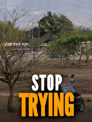 A landscape image featuring a dark-colored SUV parked on a dirt road. In the background, there are trees, vegetation, and some buildings. A person is standing near the vehicle. Overlayed on the image are large, bold orange and white text.