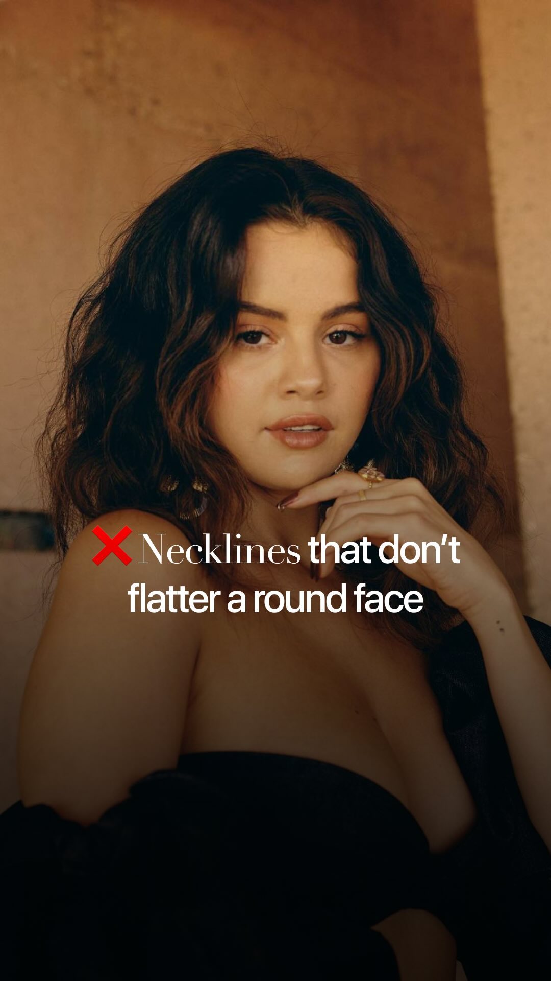 The cover image is a portrait of Selena Gomez. She is positioned with her head and shoulders visible, looking towards the viewer. She is wearing a dark outfit and has her hand under her chin with some rings visible on her fingers. Text overlayed on the image reads, "Necklines that don't flatter a round face," with a red 'X' icon to the left of the text.